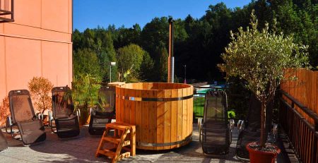 pic Wood-fired Hot Tub flexibility and possibility to use it in any seasons allow considering the tub as a challenging option of a vitality pool or jacuzzi. On top of that, a small company will find this tub to be great fun. These tubs are made of wood, which has passed a special heat-treatment process. It gives good resistance to weather conditions and precipitation. Over the years, wooden products retain their original appearance, however, the problem of care and tightness is easier and more reliable to solve in a seamless design. It is worth considering the size and shape of the wood-fired hot tub, because the product should definitely fit the overall recreation interior and the place to take hydrotherapeutic procedures. They should be comfortable, functional and aesthetic. The Wood-fired Hot Tub size directly depends on its shape and standard parameters. In addition, there are tubs for two, three, four and more people. Depending on where you are going to arrange the wood-fired hot tub and how many people will use it at the same time, it is possible to choose these or those parameters. When choosing a wood-fired hot tub, pay attention to product dimensions: length width height For example, a two-person Wood-fired Hot Tub can be from 100 cm in diameter for oval models. The length of round Wood-fired Hot Tub is from 160 cm and more. Take into account, if the average height of a Wood-fired Hot Tub is 120 cm, its useful height from the bottom will make 110 cm, as the wood-fired hot tub bottom (because of natural ventilation and installation of drain communications) is placed approximately 10 cm from the floor. You can combine the beauty of wood texture and absolute water resistance in a combined design. Its outer part consists of wooden slats, like a classic Wooden Hot Tub. Inside the wooden tub is installed a liner made of fiberglass, which does not require special care, unlike wood. The Wood-fired Hot Tub is most often made in geometric forms; it may be rectangular, octagonal, round or oval shape. The size and shape of the Wood-fired Hot Tub determine the capacity and speed of water heating. Heating water in the Wood-fired Hot Tubs with a Wood-burning stove is the most popular type. This is a simple and economical option and quite coincides with the majority of people about the right rest. Water heats up quickly (1-3 hours depending on the volume of the wood-fired hot tub, and the power of the furnace used). This is very important in regions with cold climates. If you do not know which shape of the Wood-fired Hot Tub to choose, how to calculate its size, color and material, we recommend you to contact our sales team. We will be glad to help choose the best model customized for your space and place of further use.